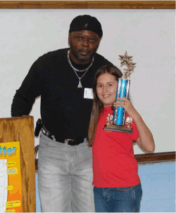 Sam Calvin presents a tropy to one of the poetry contest winners