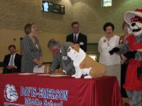 Dr. Frank Costanzo signs adoption certificate for Davis-Emerson Middle, Realty South and Whitehead & Associates