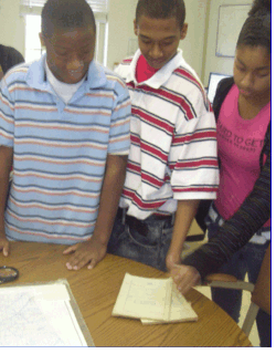 JAG students viewing the 3-D map without 3-D glasses to compare the view with and without the special effects paper glasses.