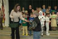 Krista Poole distributes "Gotcha Gater" buttons to Westwood students